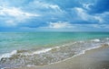 Dark Rain Clouds over turquoise Sea and sand Beach Royalty Free Stock Photo