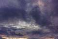 Dark rain clouds during sunset. Dramatic sky during sunset. Dark storm clouds with black and white highlights. Royalty Free Stock Photo