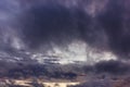Dark rain clouds during sunset. Dramatic sky during sunset. Dark storm clouds with black and white highlights. Royalty Free Stock Photo