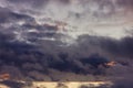 Dark rain clouds during sunset. Dramatic sky during sunset. Dark storm clouds with black and white highlights. Royalty Free Stock Photo