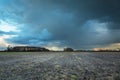 Dark rainy clouds over a plowed field Royalty Free Stock Photo