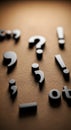 Dark raised punctuation marks displayed on a rich warm textured surface. Question marks, exclamation symbols, commas Royalty Free Stock Photo