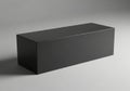 A dark rectangular box sits on a plain surface isolated on white background Royalty Free Stock Photo