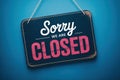 Dark rectangular sign with rounded corners says sorry we are closed Royalty Free Stock Photo