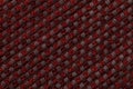 Dark red background from checkered pattern textile, closeup. Structure of the wicker fabric macro. Royalty Free Stock Photo