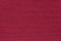 Dark red background from a textile material with wicker pattern, closeup. Royalty Free Stock Photo