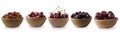 Dark red berries on a white background. Cherries, gooseberries, grapes and plums in a wooden bowl. Royalty Free Stock Photo