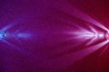 On a dark red and blue gradient fine-grained background, light blue and pink scattered rays of light Royalty Free Stock Photo