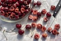 Dark red cherries cut into halves on white cutting board Royalty Free Stock Photo