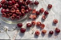 Dark red cherries cut into halves on white cutting board Royalty Free Stock Photo