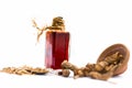 Dark red colored essence of nannari or Indian sarsaparilla in a transparent bottle isolated on white.