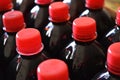 A dark red fruit syrups in plastic bottles with red lids