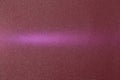 On a dark red gradient background in fine grain, a pink ray of light Royalty Free Stock Photo