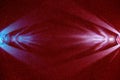 On a dark red gradient fine-grained background, light blue and pink scattered rays of light Royalty Free Stock Photo