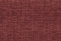 Dark red knitted woolen background with a pattern of soft, fleecy cloth. Texture of textile closeup. Royalty Free Stock Photo