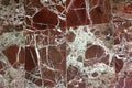 Dark red marble as a background, texture. Polished red stone with white veins. Plates of polished maroon marble Royalty Free Stock Photo