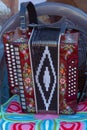 Dark red modern button accordion stands on a chair Royalty Free Stock Photo