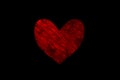 Dark red painted heart on a black background