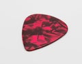 Dark red plastic guitar plectrum isolated on white background. Royalty Free Stock Photo