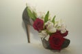 Dark red roses and flowers in green shoe