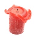 dark red short thick wax candle curling out in a strange way Royalty Free Stock Photo