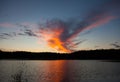 Dramatic red sky with clouds and sun reflection in water with place for your text. anazing clouds, mist in the sky Royalty Free Stock Photo