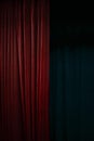 Dark red velvet curtain on one side of a black theatre stage, vertical event background with large copy space Royalty Free Stock Photo