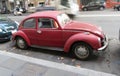 Dark red Volkswagen Beetle car parked Royalty Free Stock Photo
