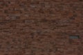 A dark red wall made of old bricks. Brick texture made of uneven elements Royalty Free Stock Photo