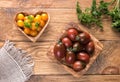 Dark red and yellow tomatoes in wooden bowls Royalty Free Stock Photo