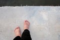 Female barefoot standing on hard cement pathway Royalty Free Stock Photo
