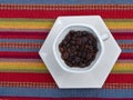 Dark roast coffee beans in cup