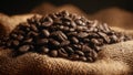 Dark roasted coffee beans on burlap sack in warm light Royalty Free Stock Photo