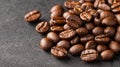 Dark roasted coffee beans scattering, forming an aromatic and energetic texture pattern on background black clean Royalty Free Stock Photo