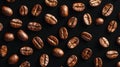 Dark roasted coffee beans scattering, forming an aromatic and energetic texture pattern on background clean a black Royalty Free Stock Photo