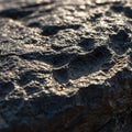 Dark rock surface with a rough, uneven texture. The image captures details of the rock Royalty Free Stock Photo