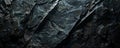 A dark, rocky texture background with rugged details and deep shadows, perfect for a bold and Royalty Free Stock Photo