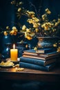 Dark room decorated with stack of books and yellow flowers and candle lights. Dark and moody room Royalty Free Stock Photo