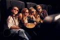 In dark room. Group of kids sitting in cinema and watching movie together Royalty Free Stock Photo