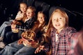 In dark room. Group of kids sitting in cinema and watching movie together Royalty Free Stock Photo