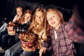 In dark room. Group of kids sitting in cinema and watching movie together Royalty Free Stock Photo