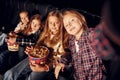 In dark room. Group of kids sitting in cinema and watching movie together Royalty Free Stock Photo