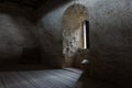 Dark room with stone walls and window Royalty Free Stock Photo