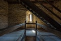 Dark room with stone walls window and wooden staircase Royalty Free Stock Photo