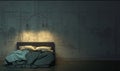 Dark room in the twilight with empty bed standing on the floor in front of the concrete wall. Gloomy interior in loft style with