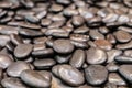 Dark round pebble stone, river rock texture background. Royalty Free Stock Photo