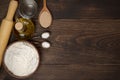 Dark rural background with ingredients for pizza dough.