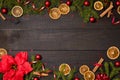 Dark rustic wood table flatlay - Christmas background with decoration and fir branch frame. Top view with free space for copy