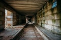 Dark scary corridor in abandoned industrial ruined brick factory, creepy interior Royalty Free Stock Photo