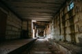 Dark scary corridor in abandoned industrial ruined brick factory, creepy interior, perspective Royalty Free Stock Photo